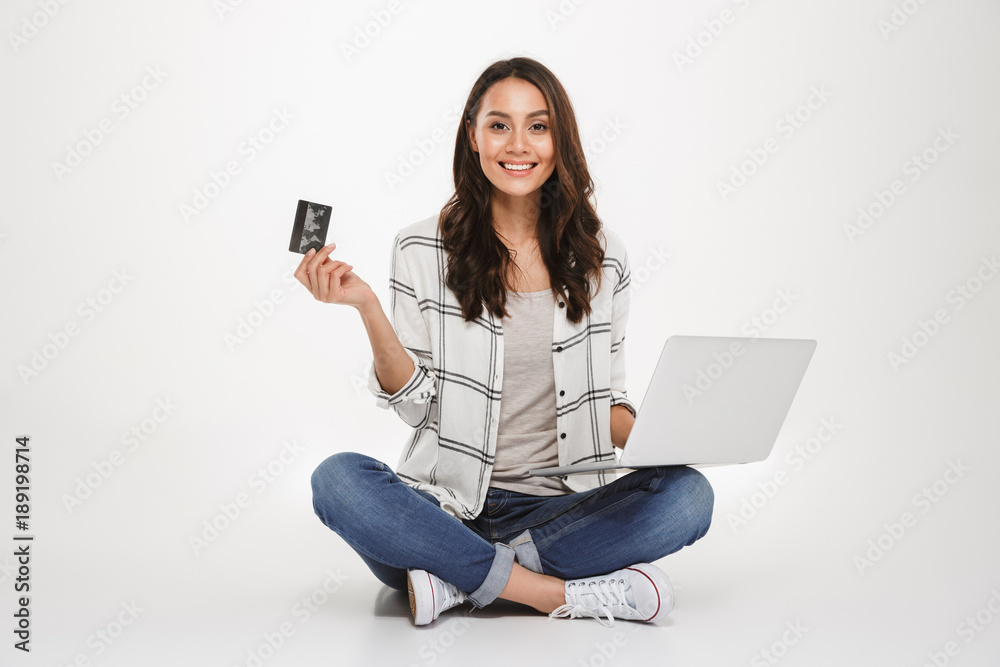 Smiling brunette woman in shirt sitting on the floor Smiling brunette woman in shirt sitting on the floor
