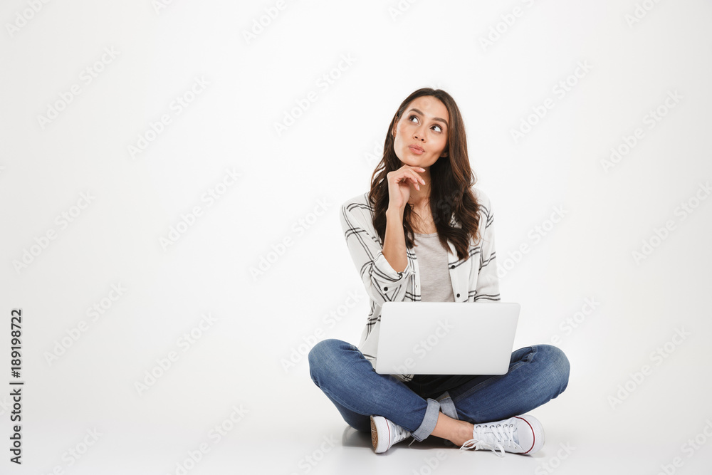 Pensive brunette woman in shirt sitting on the floor Pensive brunette woman in shirt sitting on the floor