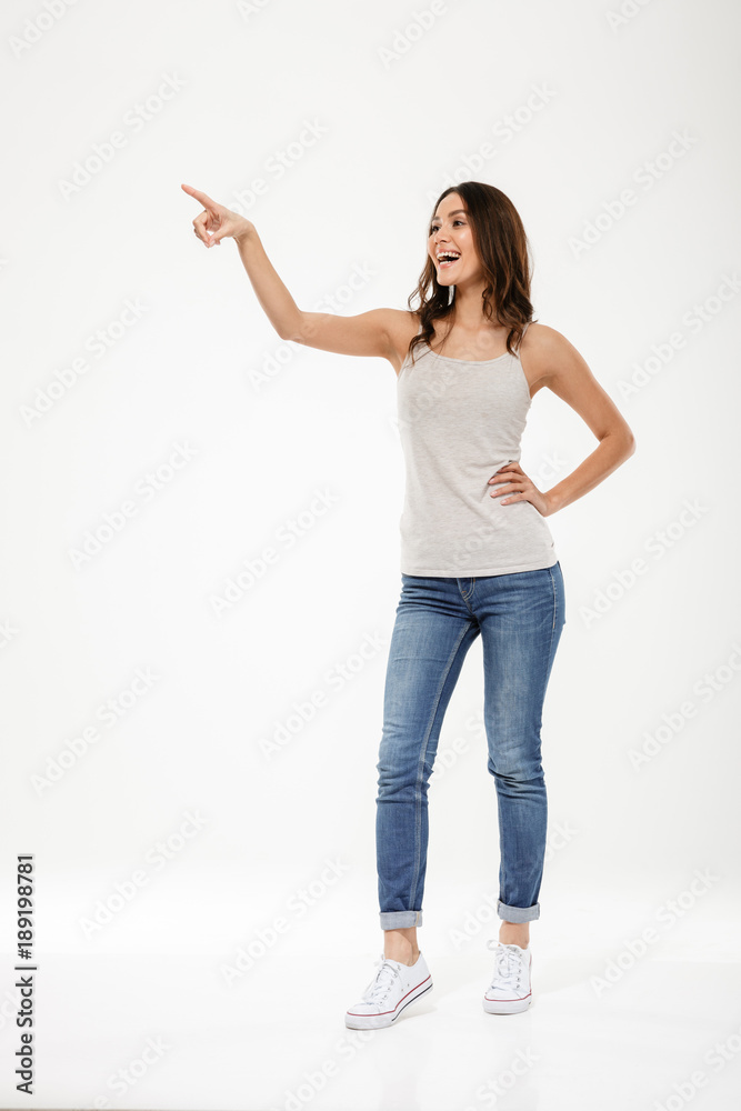 Full length image of Happy woman with arm on hip Stock Photo
