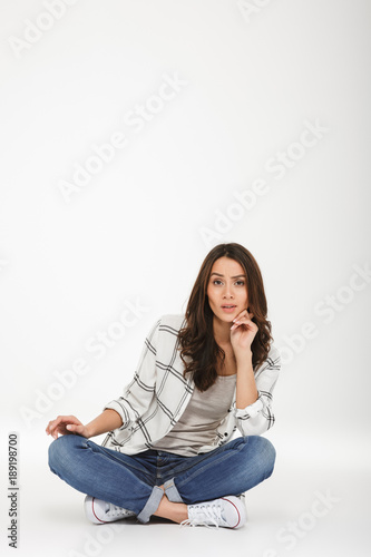 Vertical image of calm brunette woman in shirt
