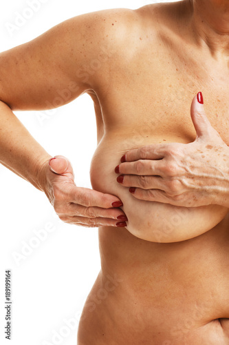 Adult Woman examining breast over white background