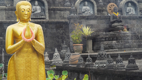 Statue of the Buddhist God Buddha in the Buddhist temple Brahma Vihara Arama with statues of the gods on Bali island, Indonesia. Bali Architecture, Ancient design. Travel concept. photo