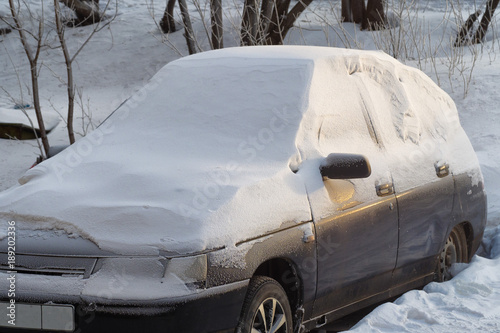 frozen car in winter day