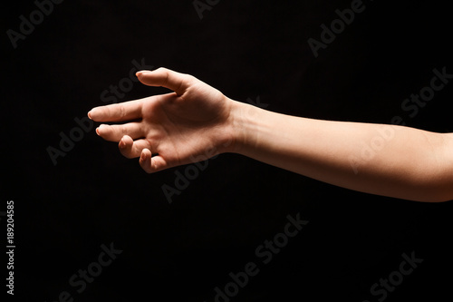 Hand ready for handshake isolated on black