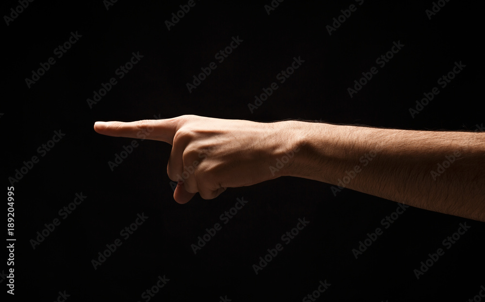 Hand gestures - man pointing, isolated at black Hand gestures - man pointing, isolated at black