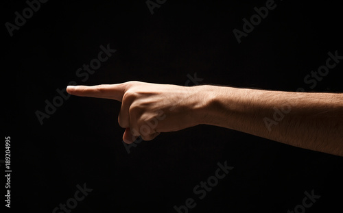 Hand gestures - man pointing, isolated at black