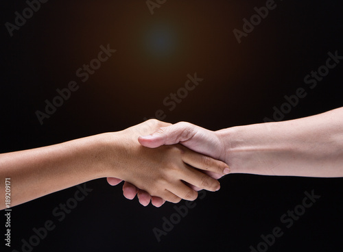Closeup human hand touch together.They are shaking hand to be sign for trust and teamwork,the collaborate concept