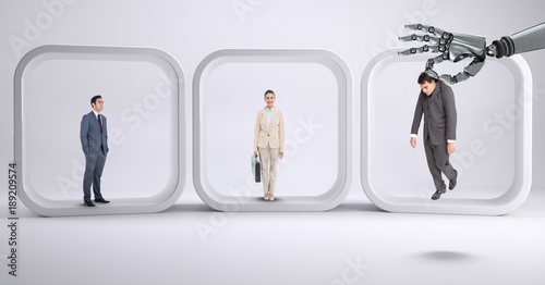 Fotografie Robot hand choosing a business man on withe background with