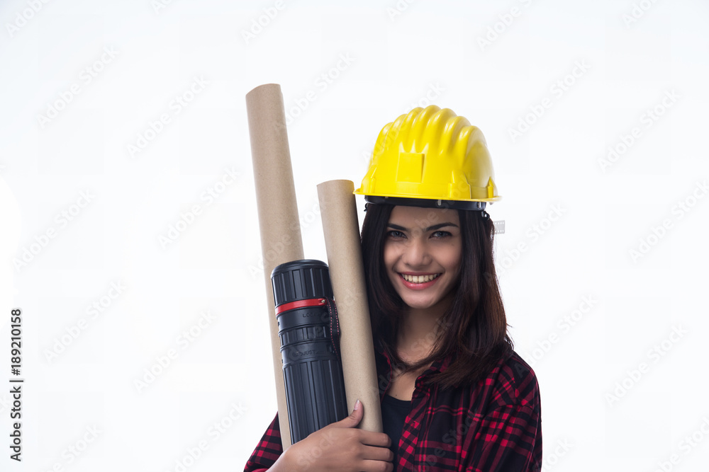 The young woman engineer with yellow safety helmet and hold blueprint in her hand The young woman engineer with yellow safety helmet and hold blueprint in her hand