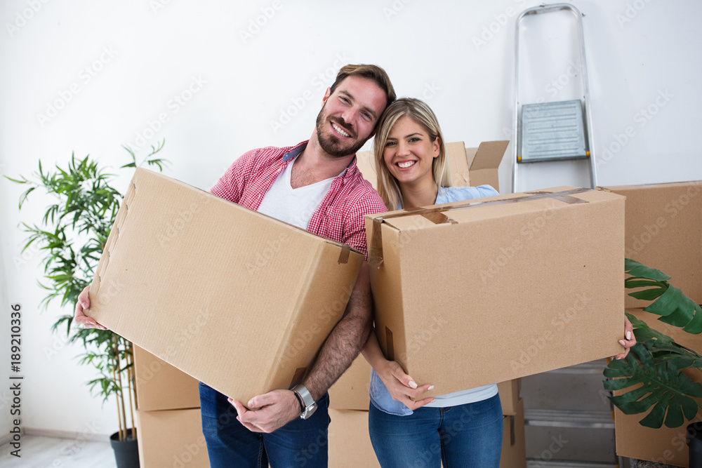 Young couple packing boxes for moving Young couple packing boxes for moving