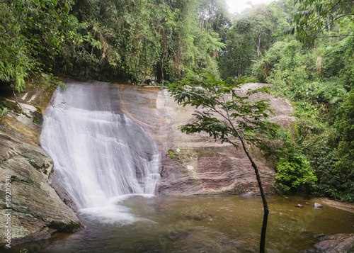 Waterfall in tropical rainforest in rural state of Rio de Janeir photo