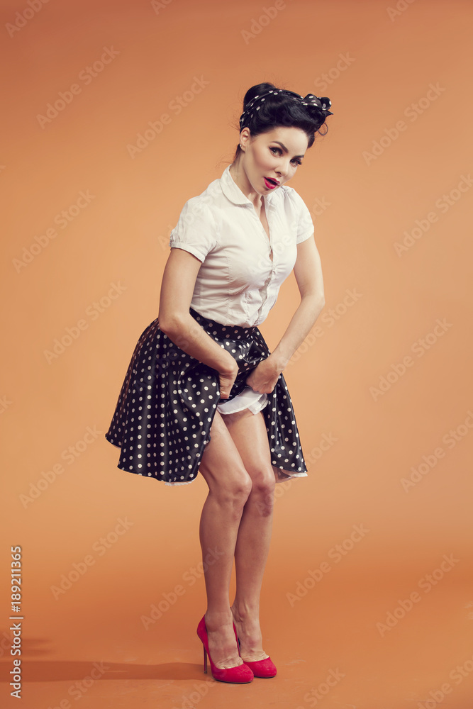 girl in vintage style lifts skirt and shows pretty feet Stock-Foto | Adobe  Stock