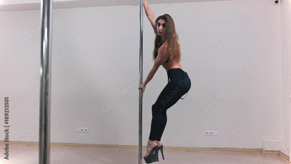 Beautiful sexy white pole dancer, woman is dancing near the pole, erotic dancing, choreography and sport, pole dancing Beautiful sexy white pole dancer, woman is dancing near the pole, erotic dancing, choreography and sport, pole dancing