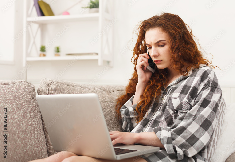 Girl with laptop and mobile sitting on beige couch. Girl with laptop and mobile sitting on beige couch.