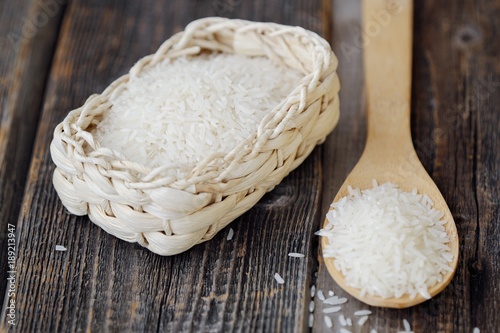 White long grain rice on a wooden spoon