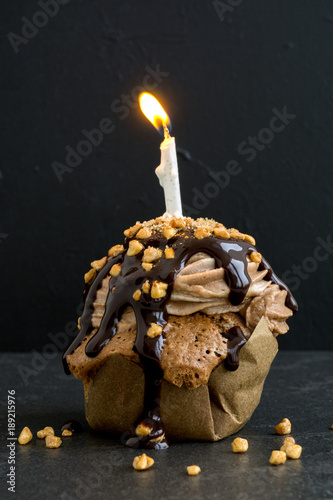 Chocolate capcake with a candle for the birthday. photo