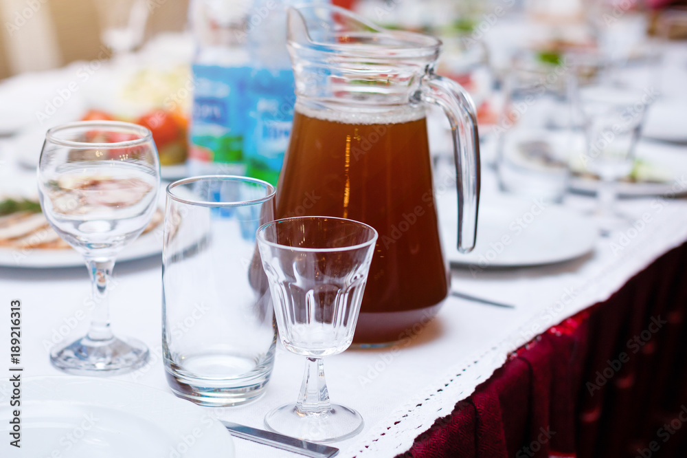 Beautiful glasses defocused on buffet table in restaurant and blurred background Beautiful glasses defocused on buffet table in restaurant and blurred background