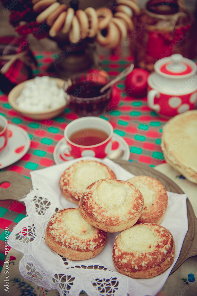 Set the table for the Shrovetide Maslenitsa. Pancakes, cheesecakes, a samovar. Set the table for the Shrovetide Maslenitsa. Pancakes, cheesecakes, a samovar.