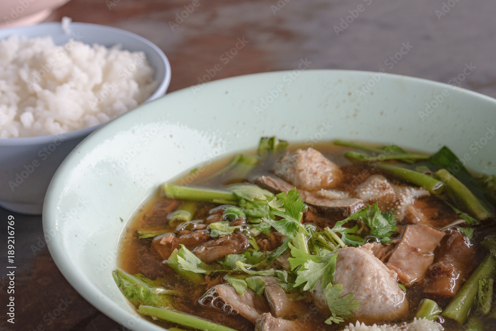 Thailand traditional ekaehla beef soup and cooked rice on the woodden table. Food thai style.
