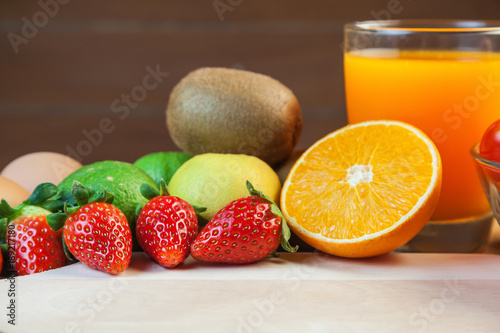 Healthy concept with mixed fruits and vegetables on wooden background
