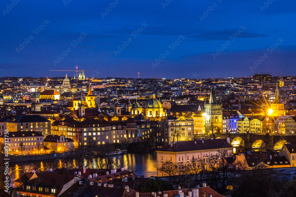 Beautiful Night view over the Vltava river, Charles bridge, the embankment Smetanovo, tower old city, Church St. Assisi and whole Prague. Popular European travel destination. Chech Republic.