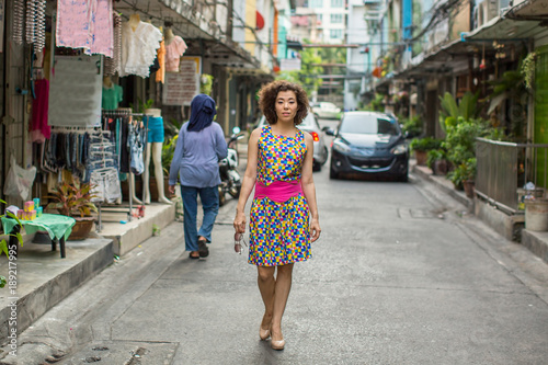 Young asian woman walking down the street.