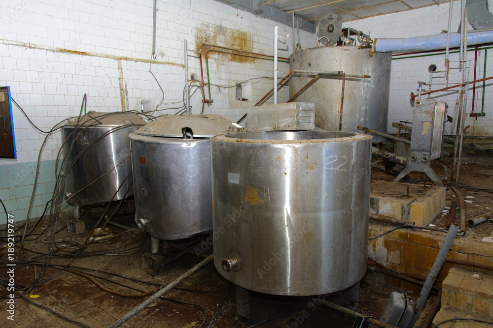 Old milk storage tanks. Premises of a destroyed and plundered milk production plant. The raiders captured the plant. Vandalism. Ukraine, January 2018.