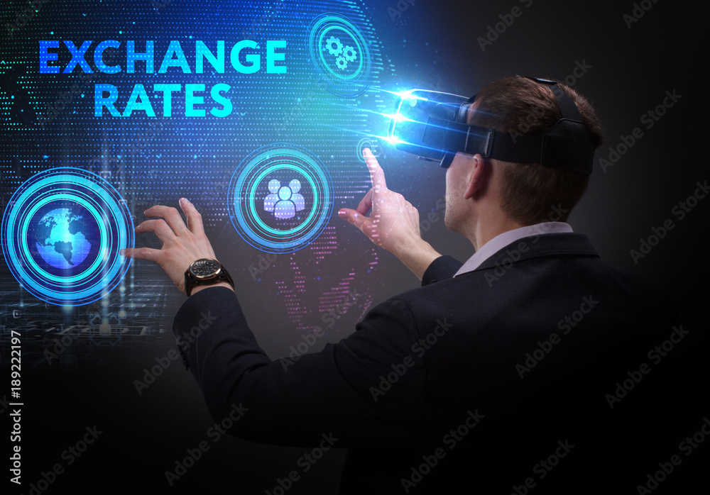 Business, Technology, Internet and network concept. Young businessman working on a virtual screen of the future and sees the inscription: Exchange rates Business, Technology, Internet and network concept. Young businessman working on a virtual screen of the future and sees the inscription: Exchange rates