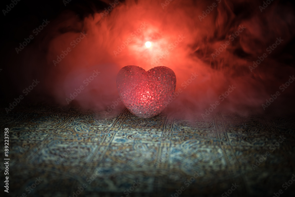 Fototapeta premium Burning LED heart. Valentine concept. Dark toned foggy background.