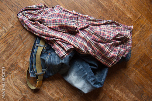 man clothes thrown on wooden floor