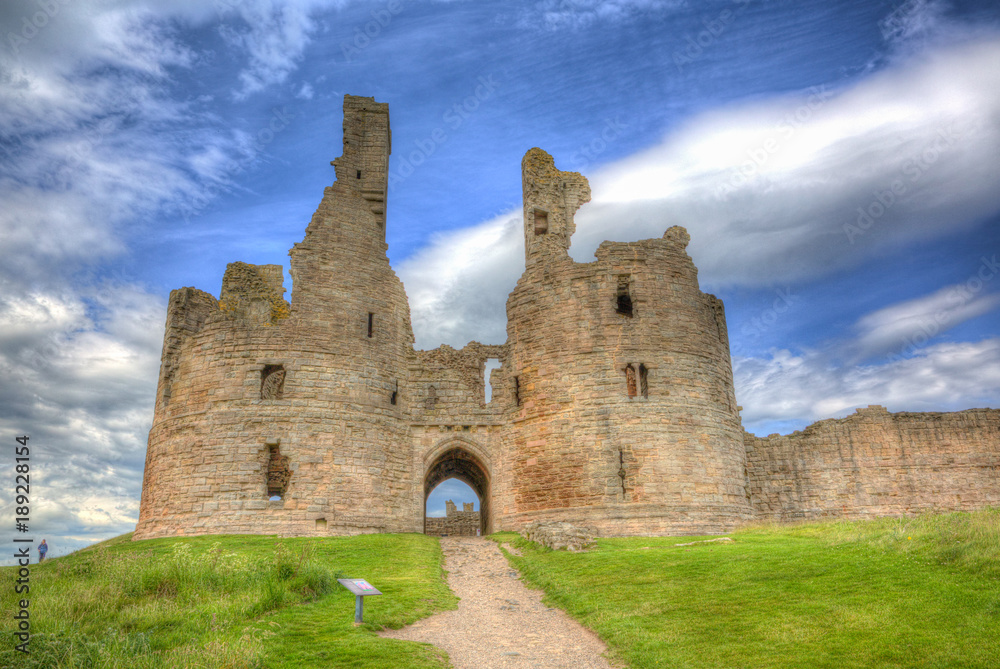 English medieval castle Dunstanburgh Northumberland England uk in colourful hdr