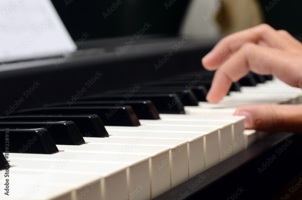 Child hands on piano keyboard Child hands on piano keyboard