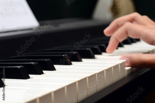 Child hands on piano keyboard