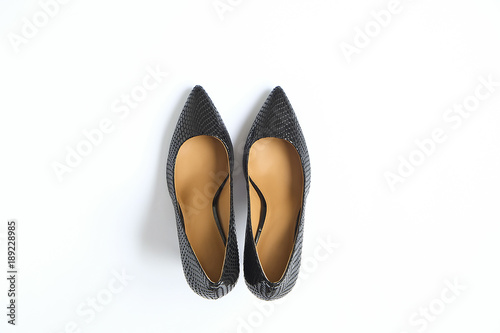 Fashionable medium heeled women's leather wedge shoes isolated on white.