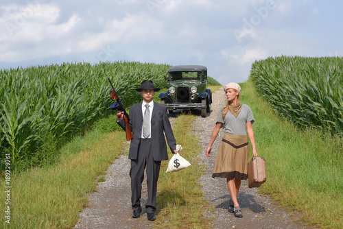 Two models get dressed up in 1930's style vintage fashion clothes and act the role of the gangster duo Bonnie and Clyde.