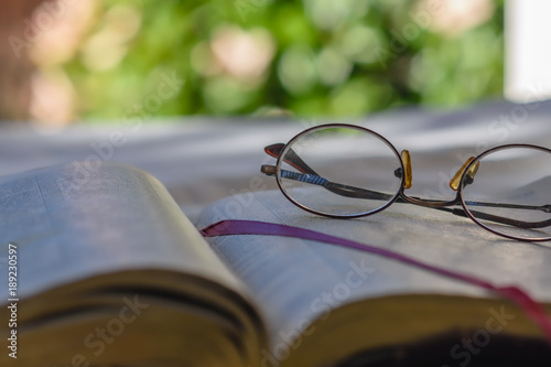 Close view of bible pages with glasses on page