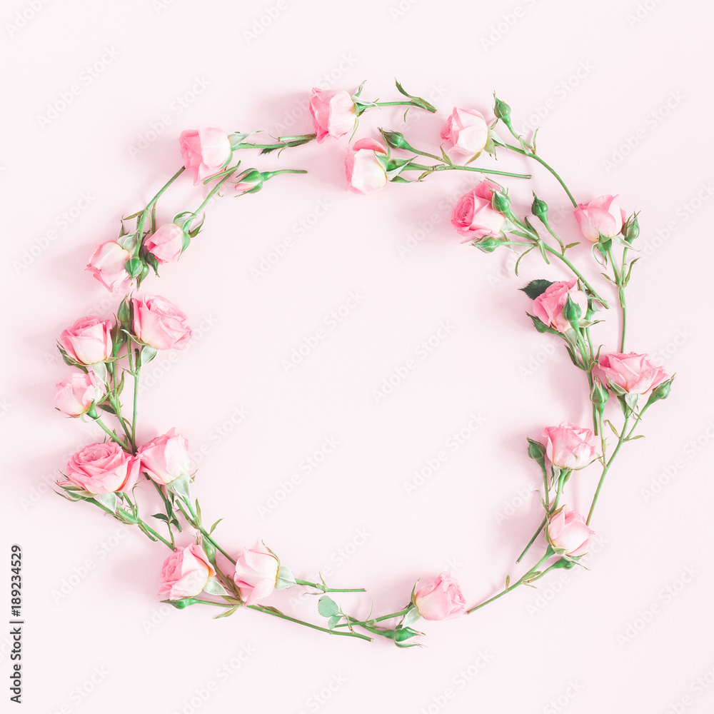 Flowers composition. Wreath made of pink rose flowers on pink background. Flat lay, top view, copy space, square