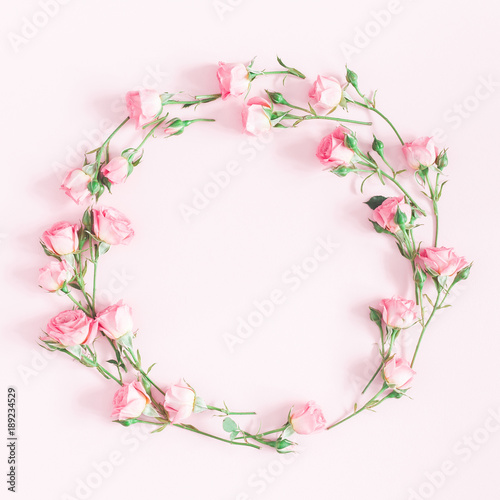 Flowers composition. Wreath made of pink rose flowers on pink background. Flat lay, top view, copy space, square © Flaffy