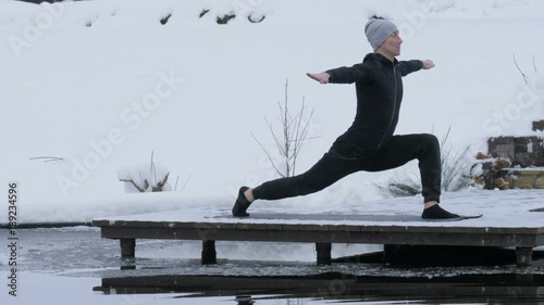 A man is meditating in nature in the winter. Yoga.