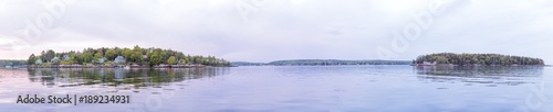 Panoramic panorama of purple sunset twilight in evening at Boothbay Harbor in small village in Maine with rocky coast and houses