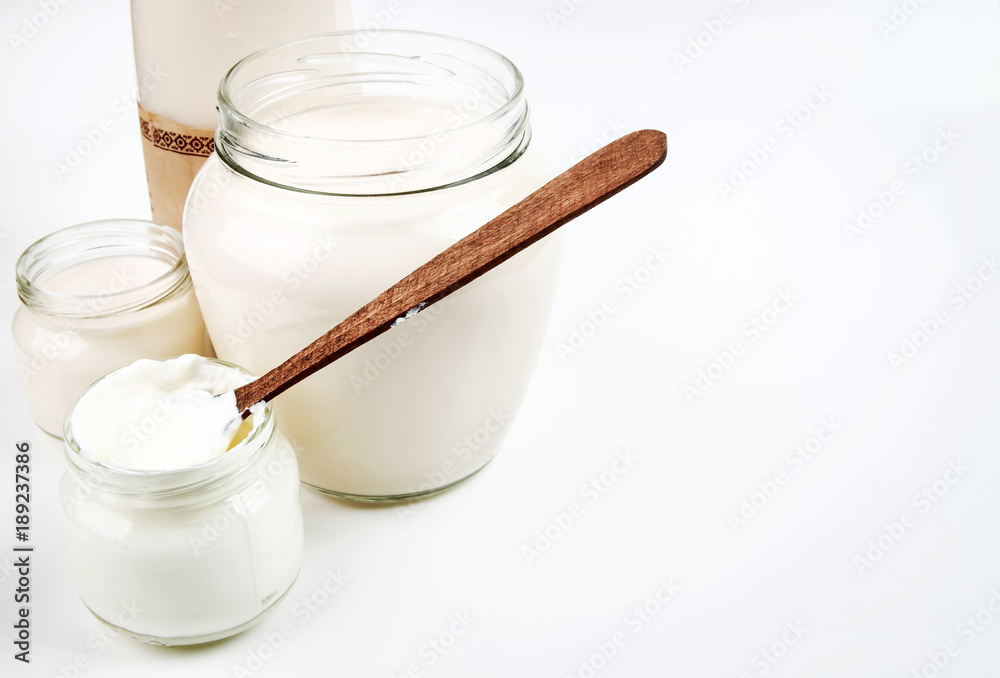 Bottle with milk and a can of sour cream isolated on white background Bottle with milk and a can of sour cream isolated on white background