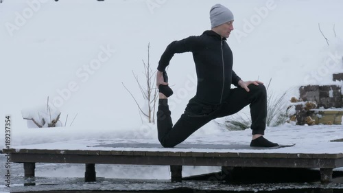 A man is meditating in nature in the winter. Yoga.