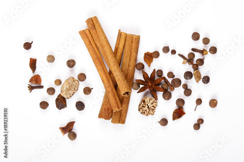 Fototapeta Naklejka Na Ścianę i Meble -  Spices for mulled wine. Spices for mulled wine isolated white background. Cinnamon sticks, roast pepper, ginger, tubberry, nutmeg, cardamom, cloves.