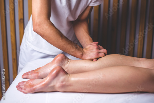 Wallpaper Mural Hands of the masseur make a foot massage lying on the couch. Torontodigital.ca