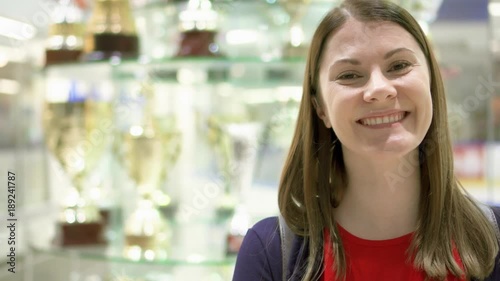 Wallpaper Mural Proud young woman standing near stand with sports awards. Female champion smiling. Golden winner cups on bakcground Torontodigital.ca