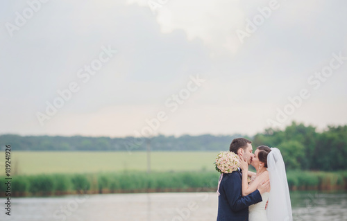 Elegant bride and groom posing together outdoors © Ryzhkov Oleksandr