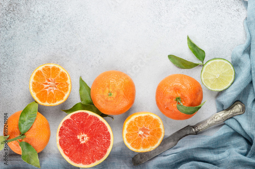 Set of citrus on table: mandarin, grapefruit, lime, tangerine with a knife. Fresh organic juicy fruits. © strekoza64