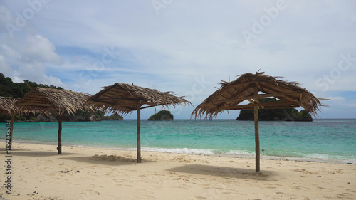 Beach with deck chairs  sun beds  umbrellas.Beach  sea  sand wave. Seascape ocean and beautiful beach paradise  blue sky  clouds. Philippines Travel concept