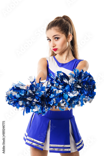 Foto Young cheerleader in blue and white suit with pompoms on white background