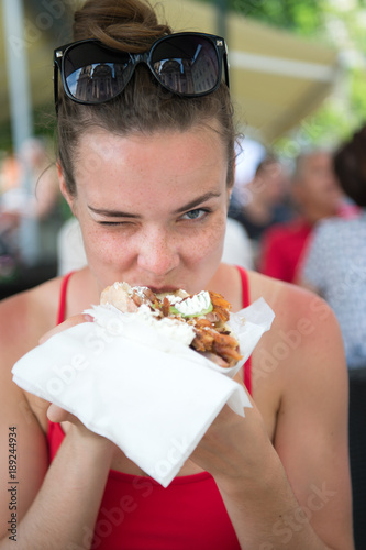 happy preatty girl or Woman eating sandwich gyros. photo